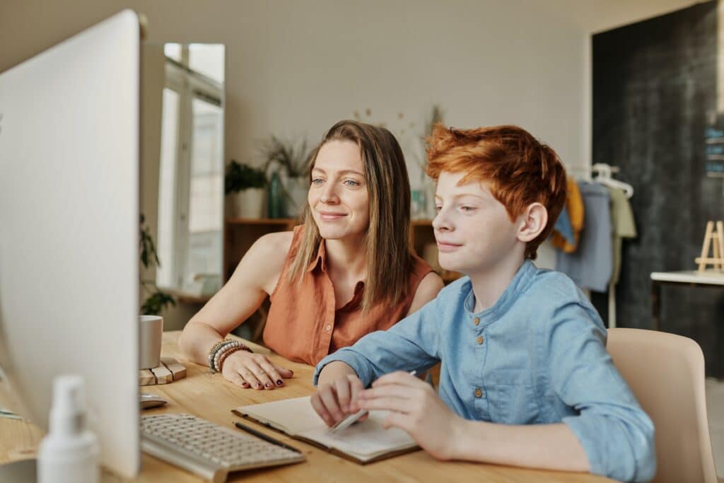 tutor and student working on a computer